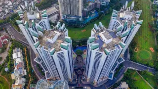 Ilustrasi: Pemandangan udara kompleks gedung apartemen tinggi dengan jalan dan area hijau di sekitarnya.
