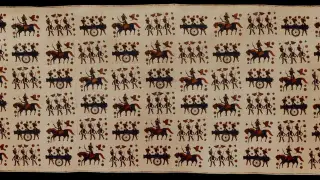 Ilustrasi: Kain batik tradisional dengan motif figur prajurit, penunggang kuda, dan meriam.